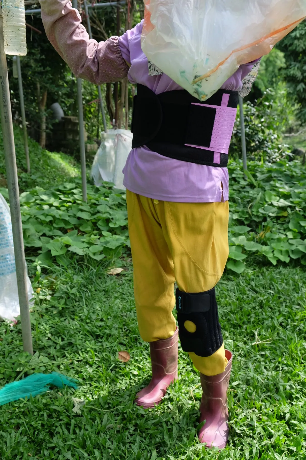 Lumbar support belt in use, worn by an older adult during daily activity
